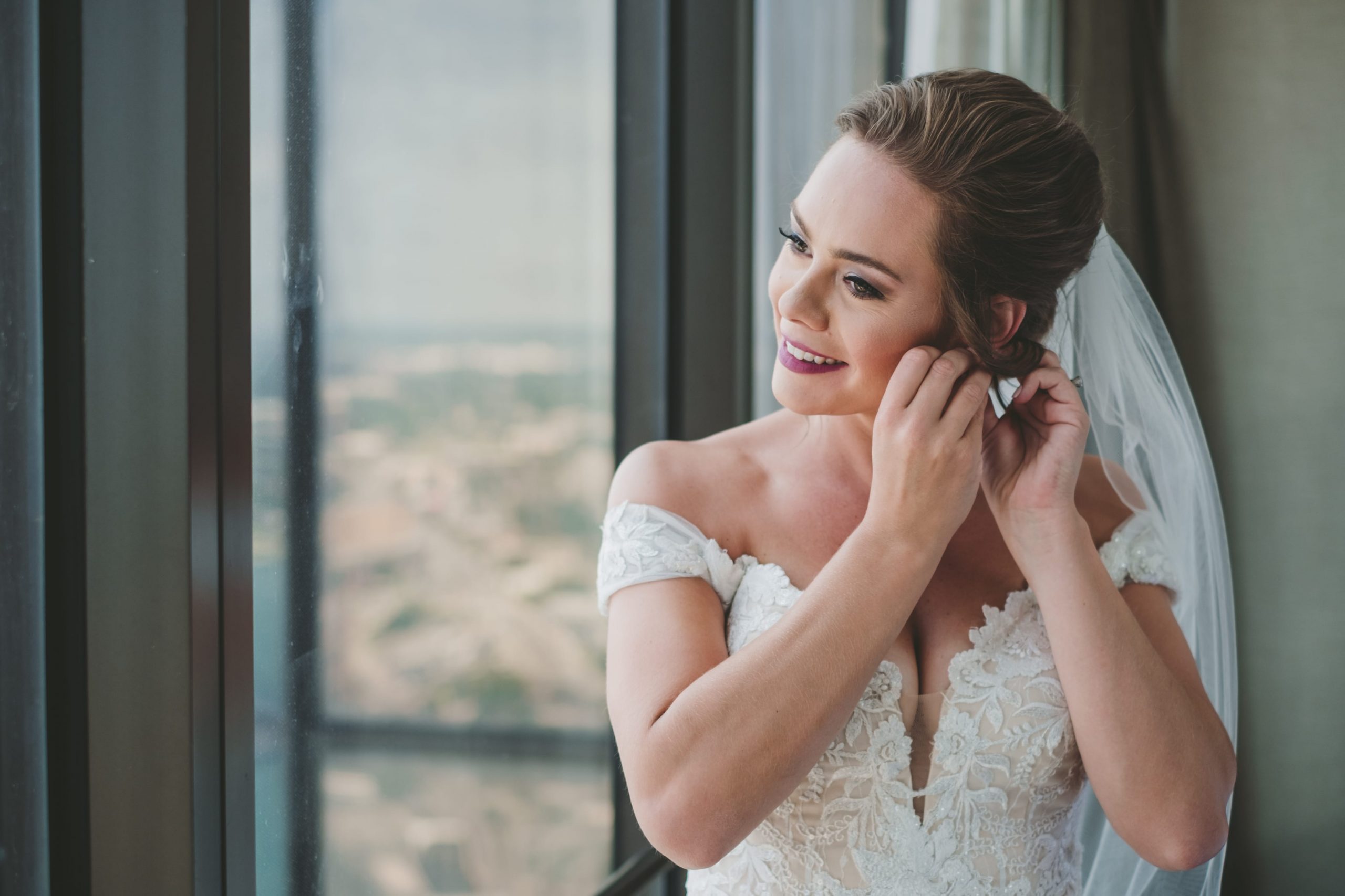 bride putting in earrings