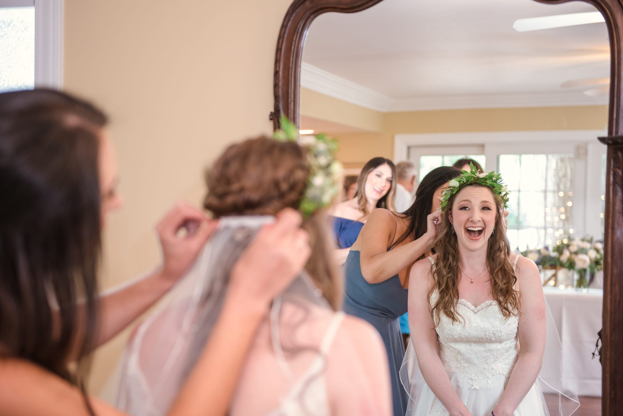 bride's excitement looking in mirror pre-ceremony