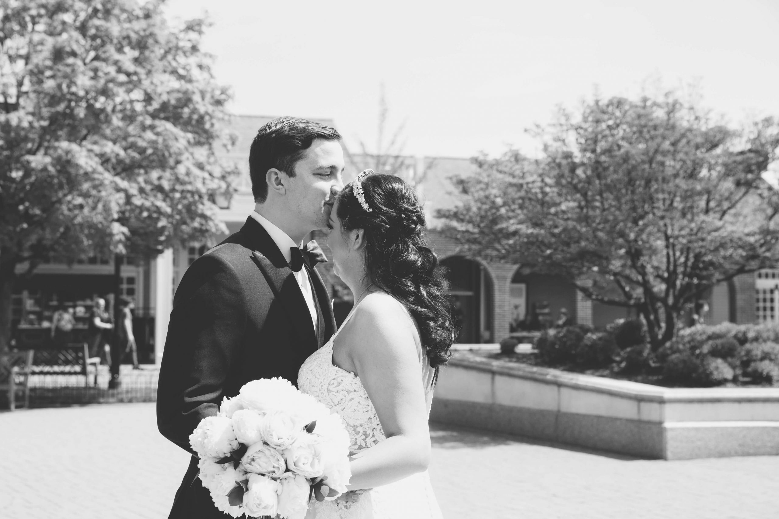 groom kissing bride on forehead