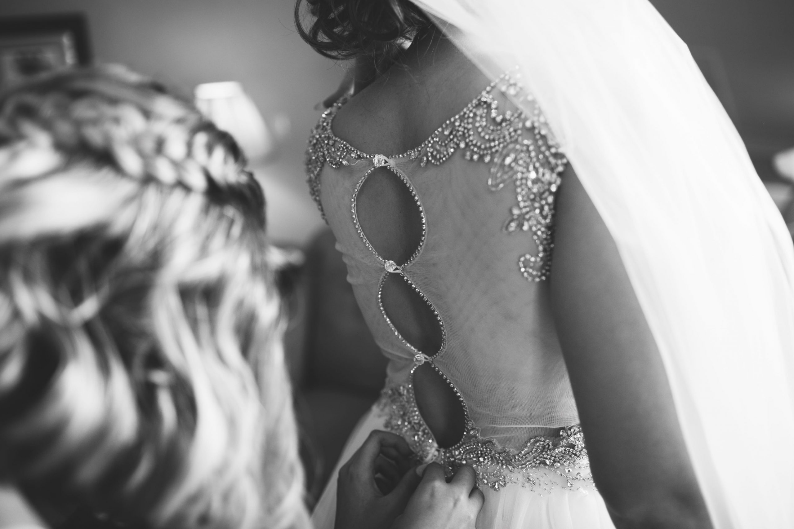 black and white photo of bride's gown details