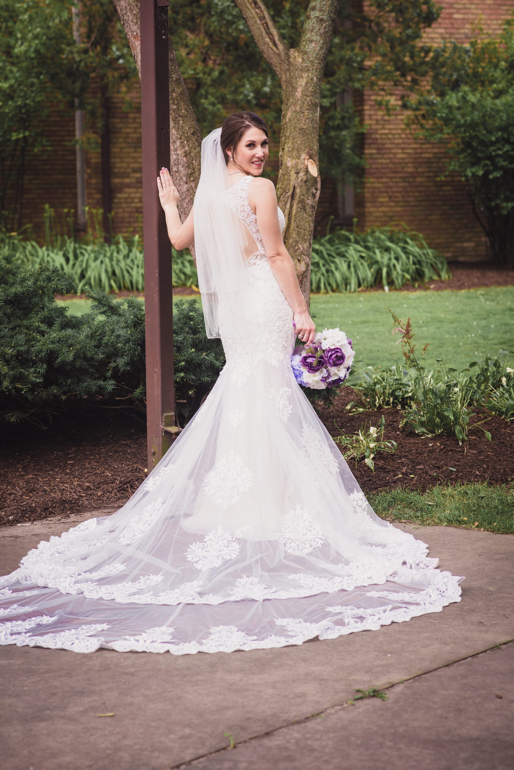 bride looking back in portrait, showing dress details