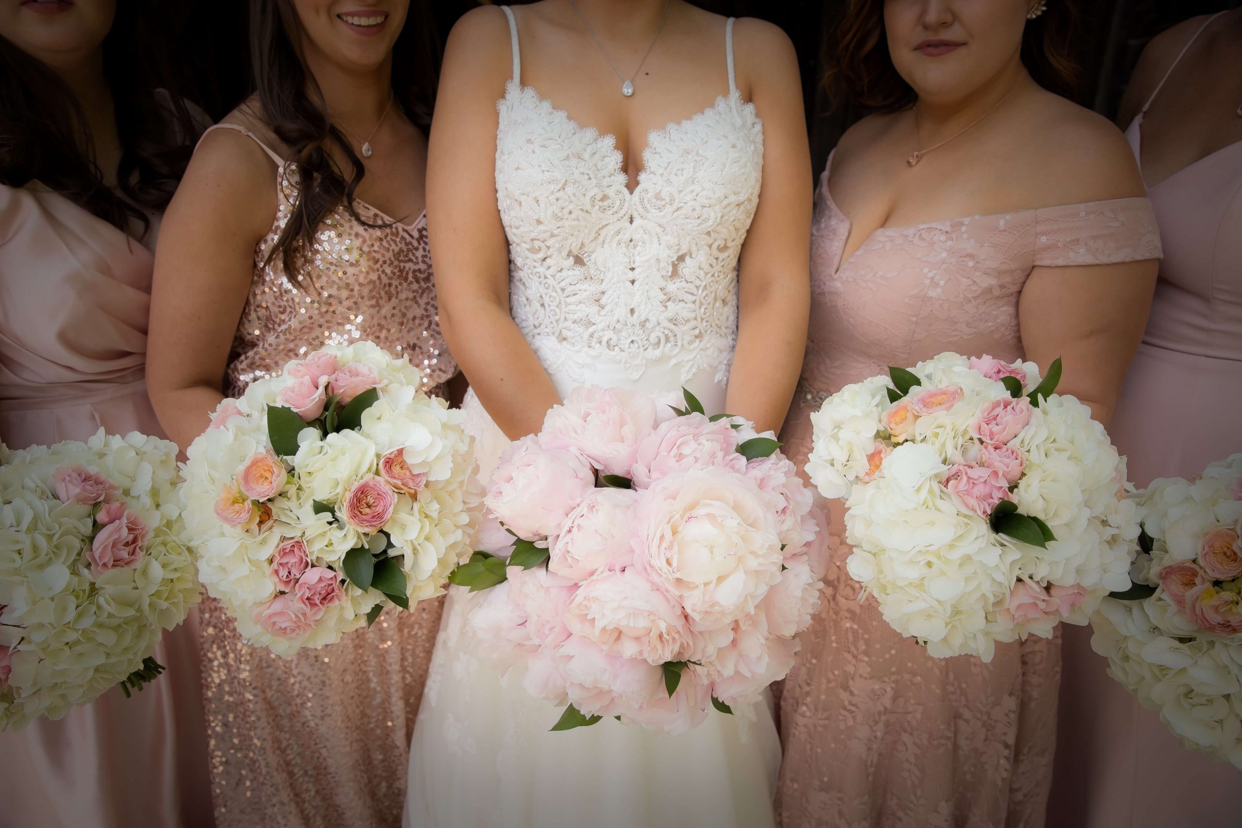 bride and bridesmaids in pink with bouquets