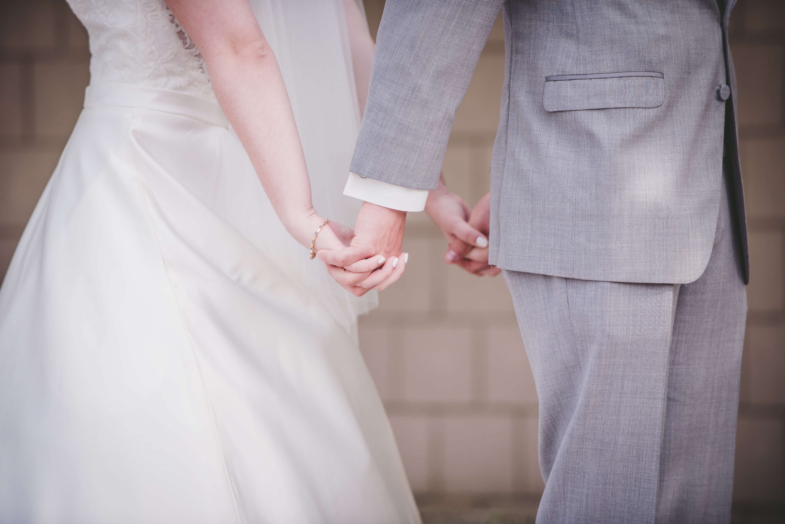 bride and groom holding hands