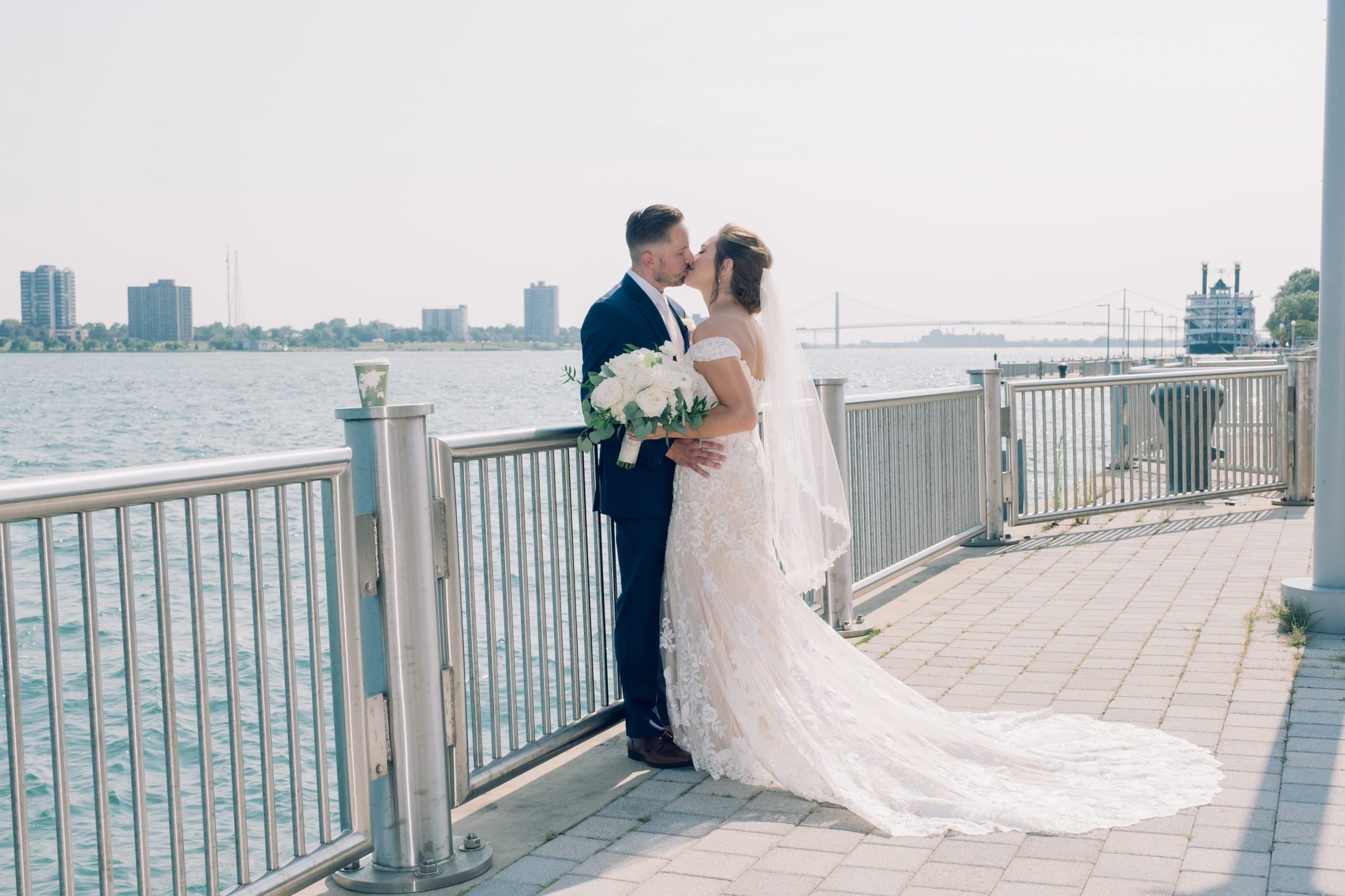 bride & groom kissing at detroit riverfront