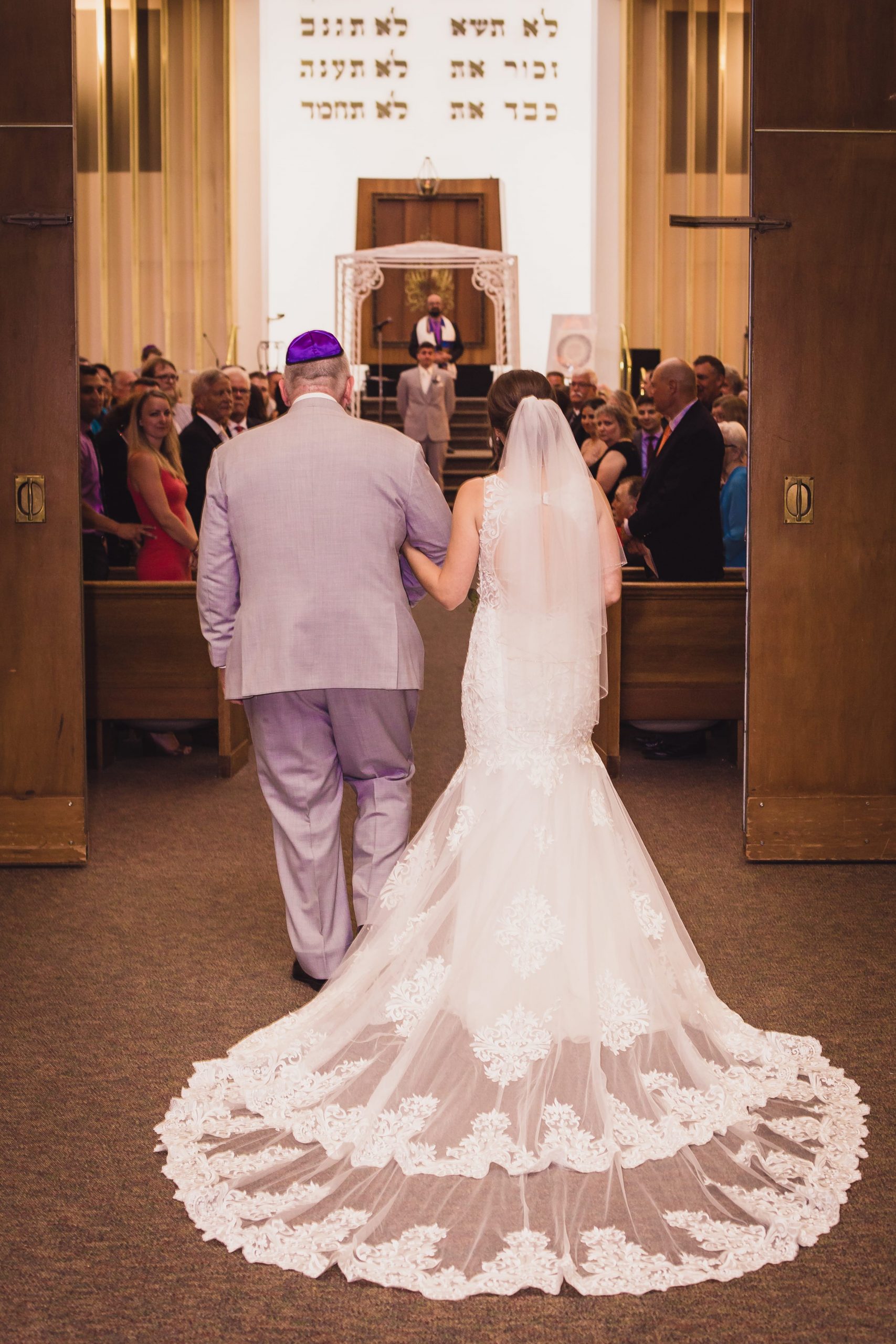 bride walking down aisle with father