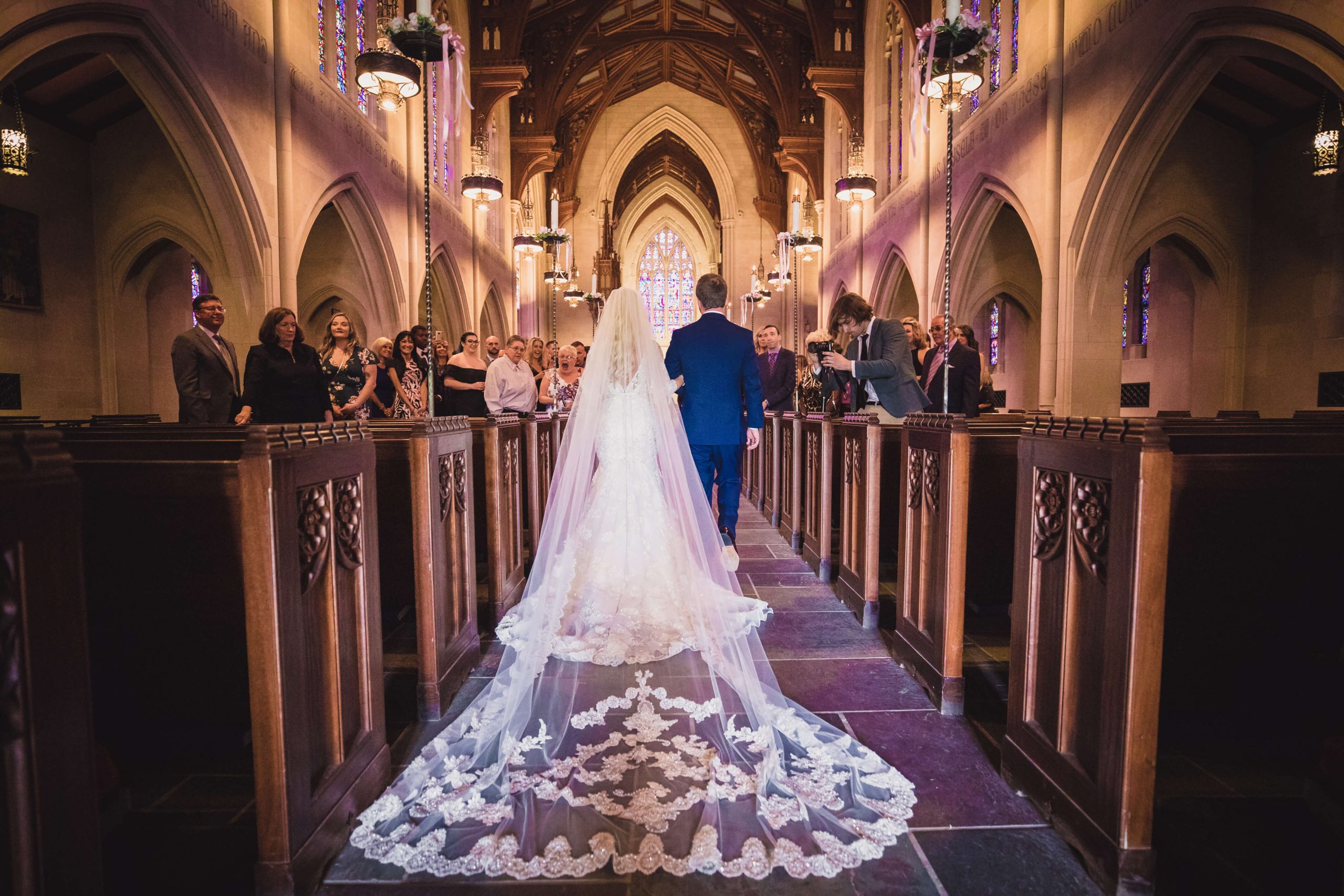 bride walking down aisle in beautiful church