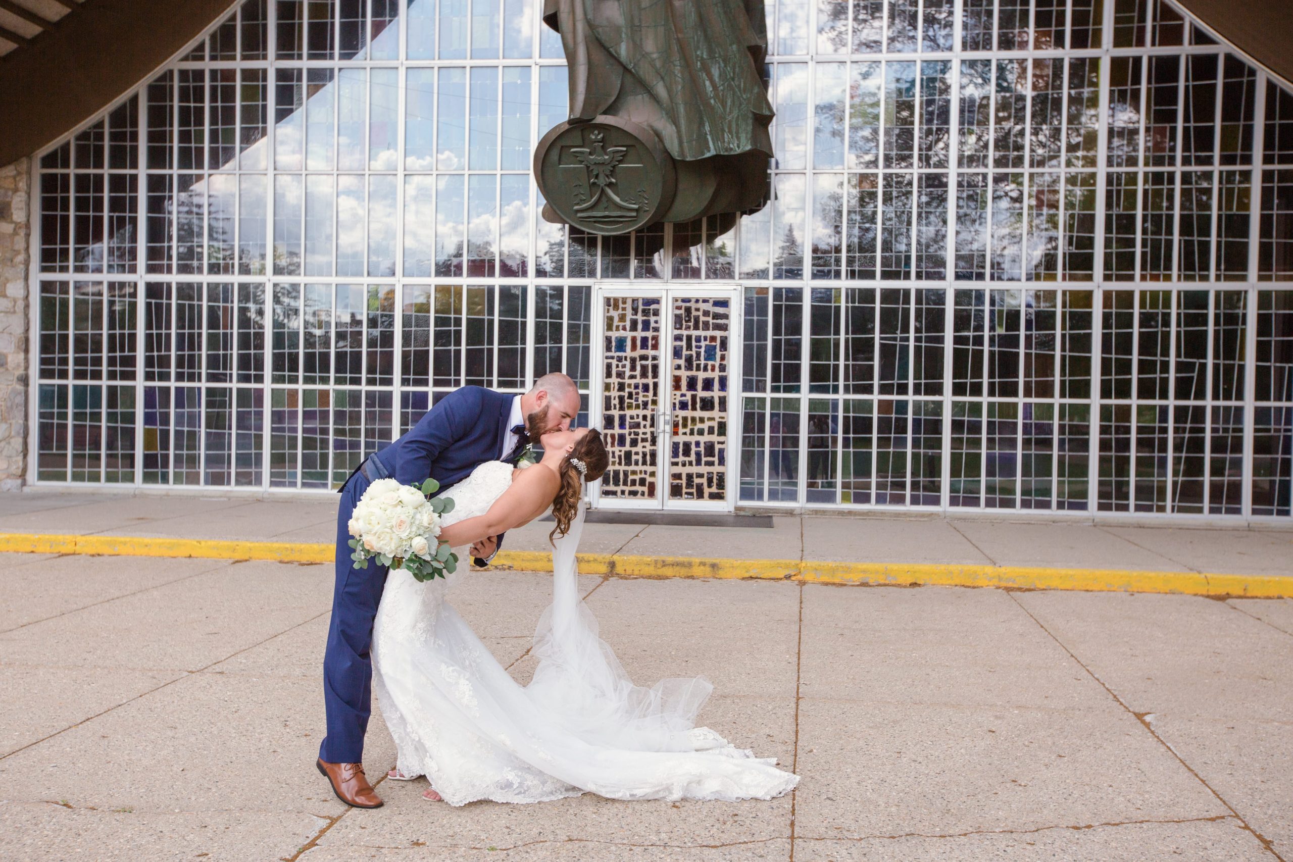 bride and groom kissing outside church