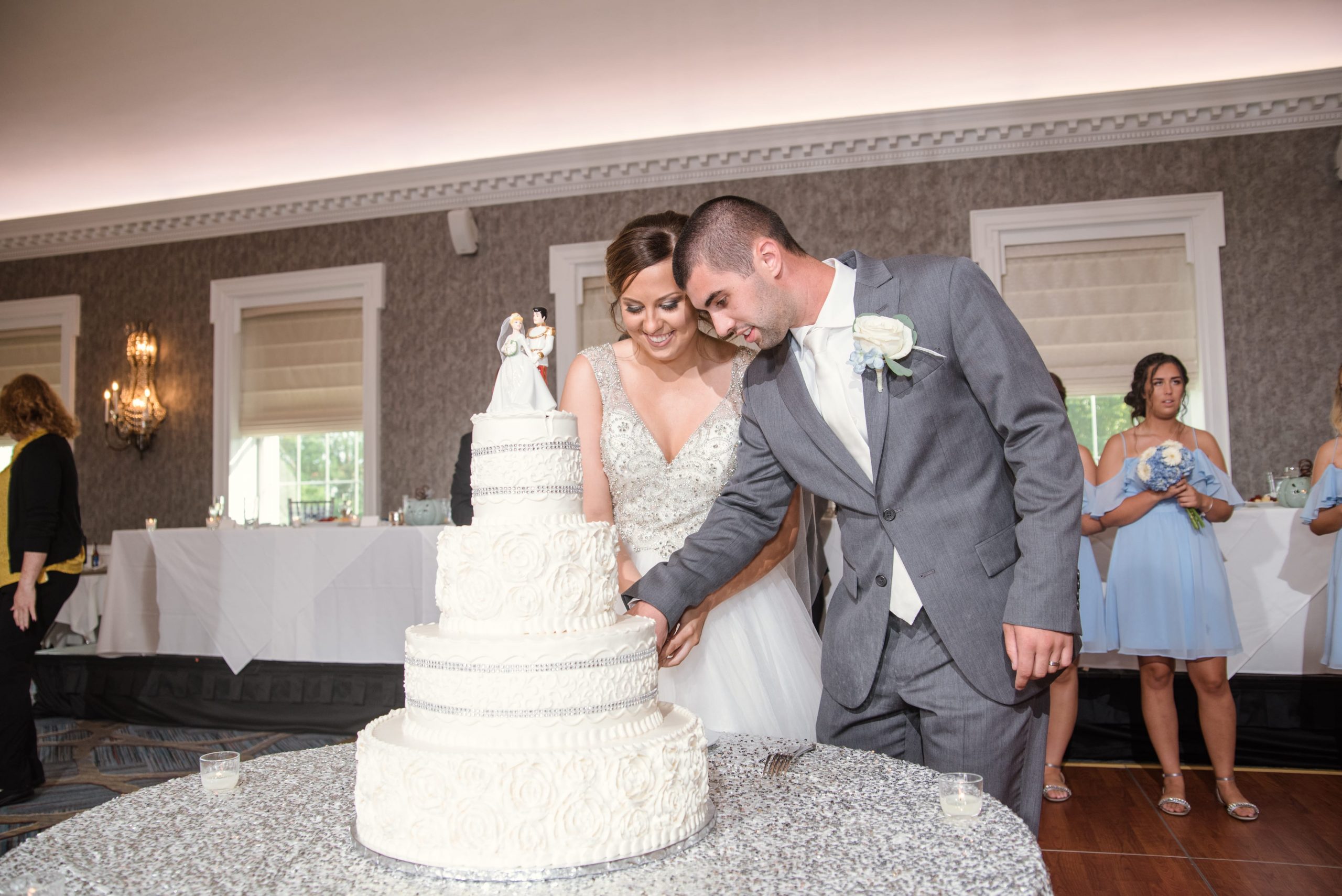 bride and groom cutting their cake