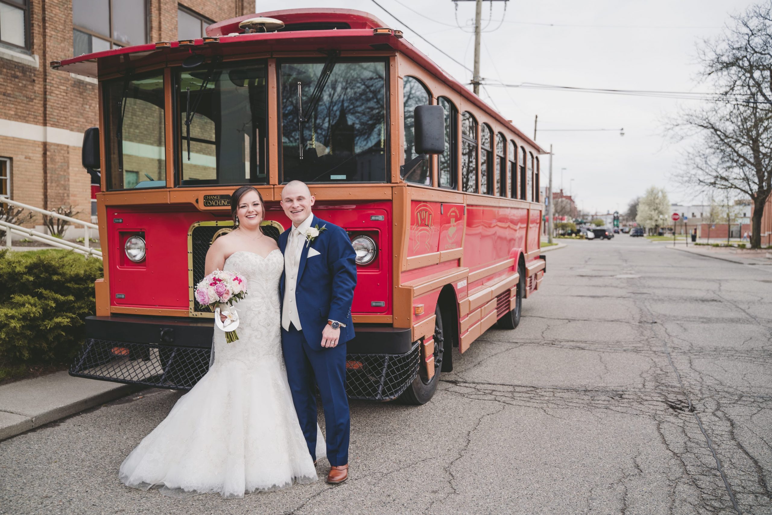 bride and groom in front of trolley