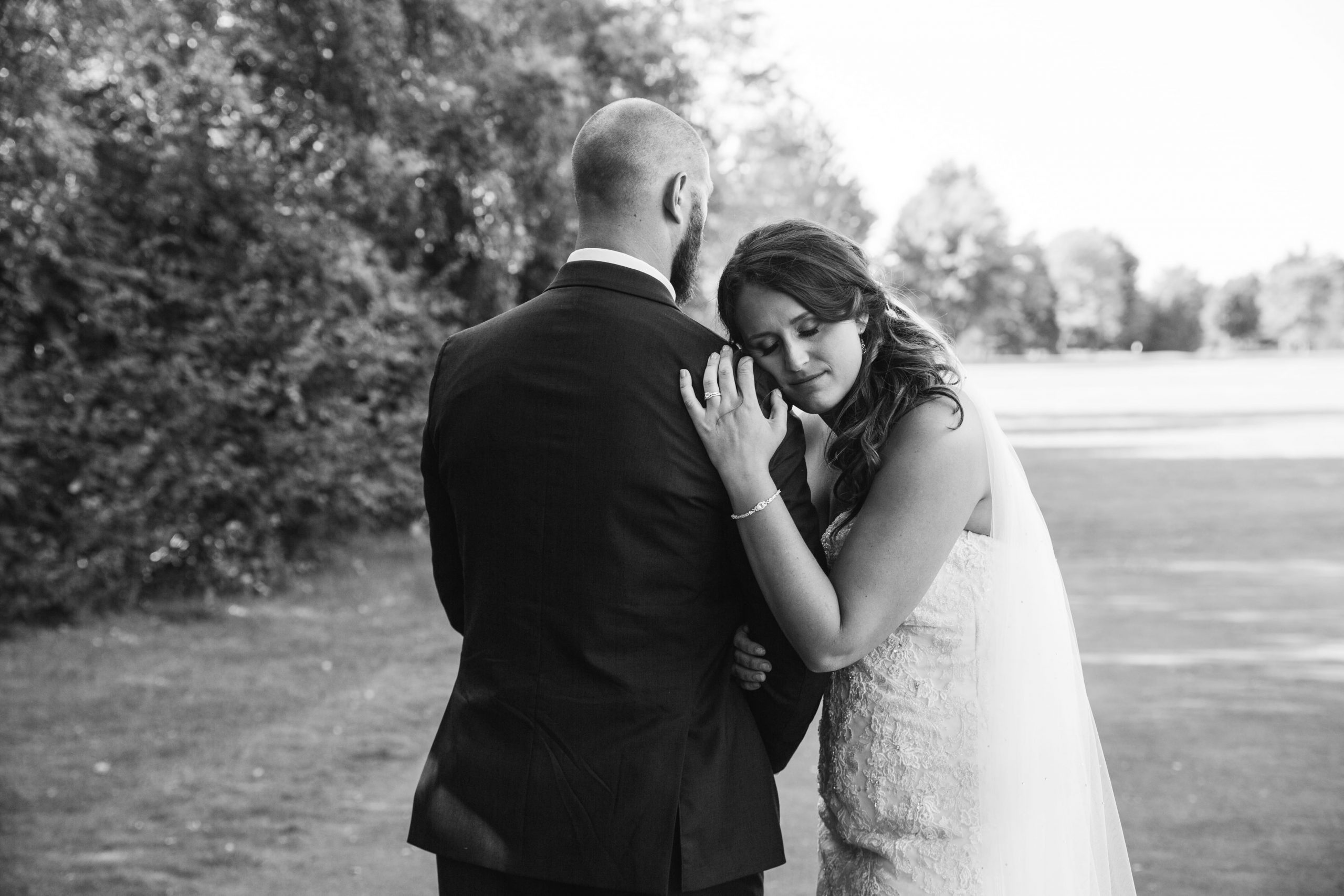 bride leaning head on groom's shoulder