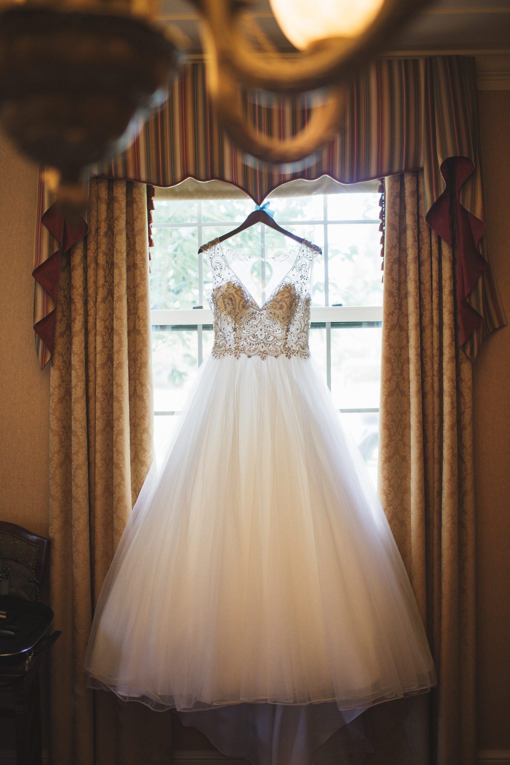 dress hanging from window with dramatic lighting