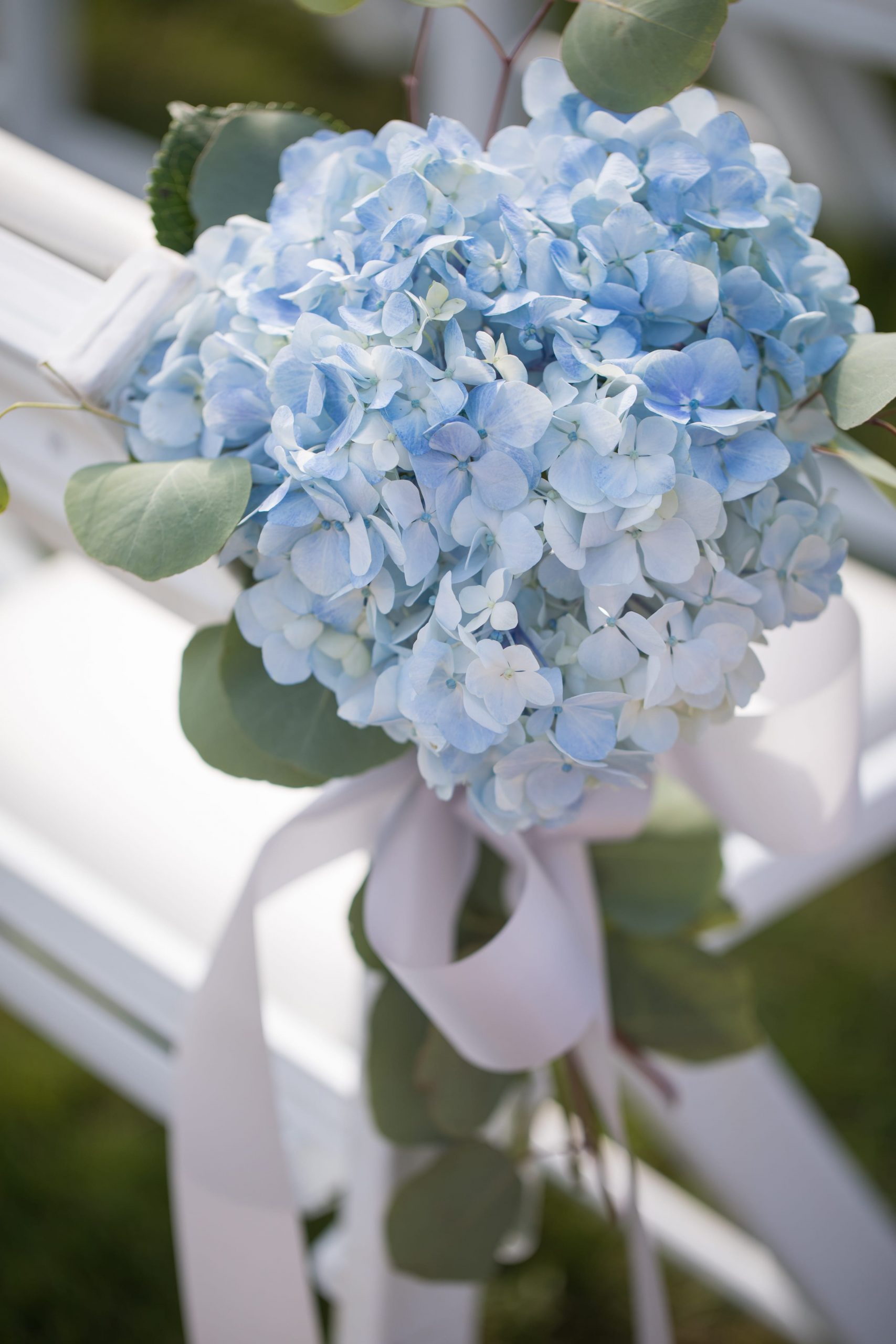 blue floral details on chairs at wedding ceremony