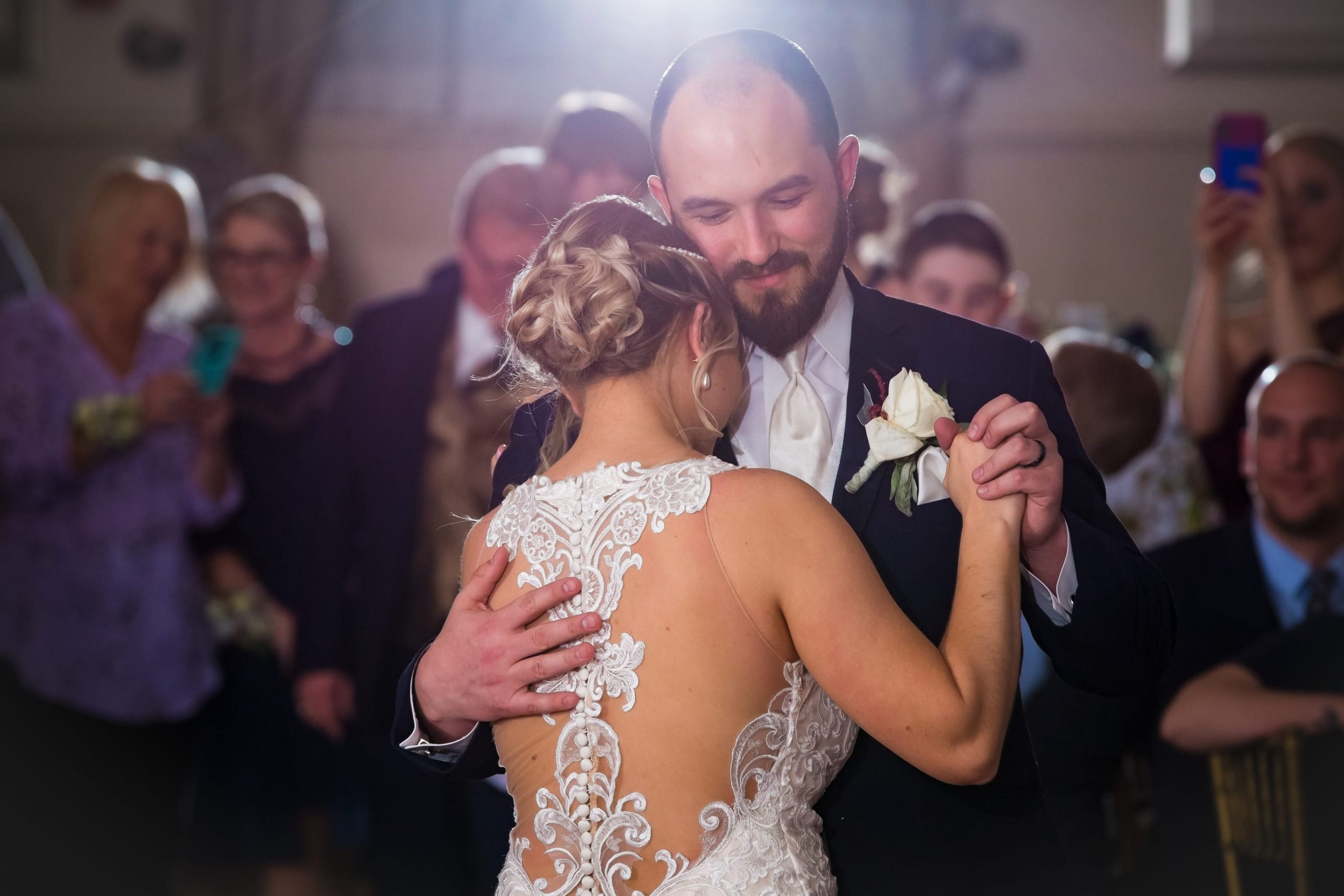 groom holding bride close during first dance