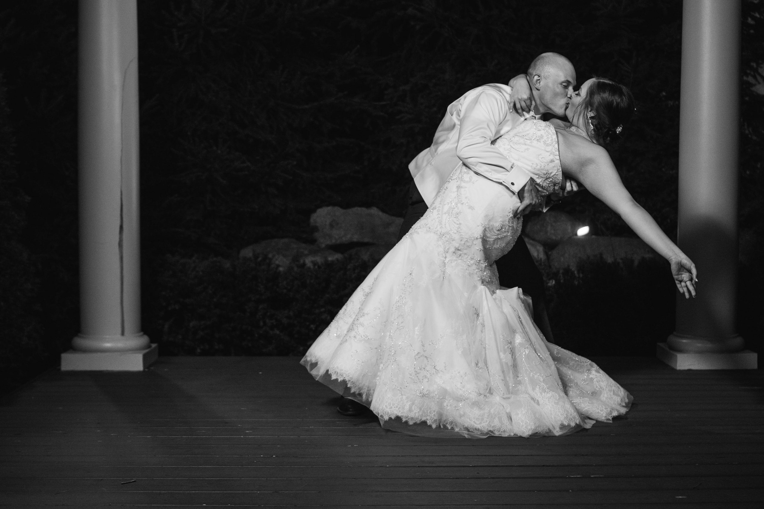 bride and groom kissing during evening romantics