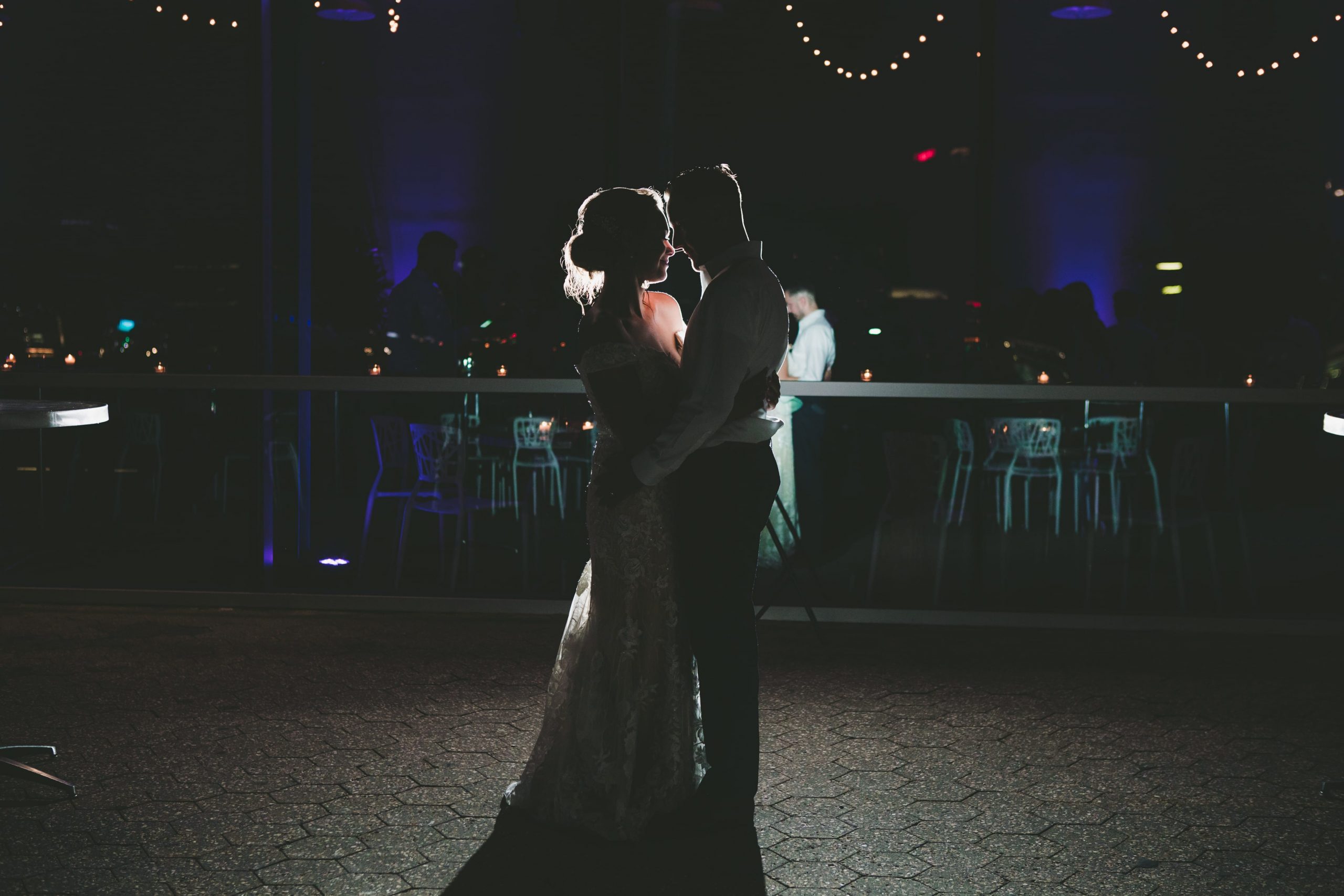 bride and groom dancing with minimal lighting