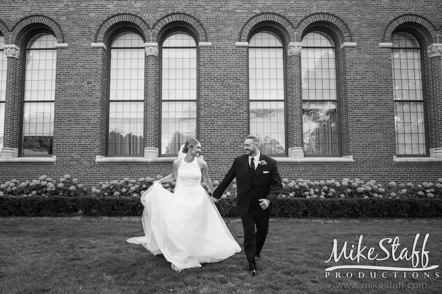 black and white or bride and groom walking towards camera