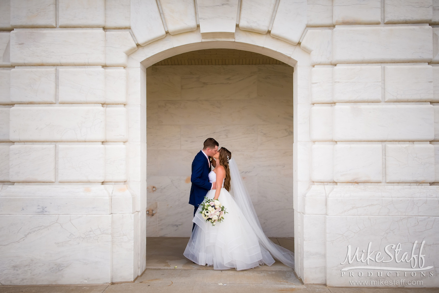 Bride and groom kissing at DIA