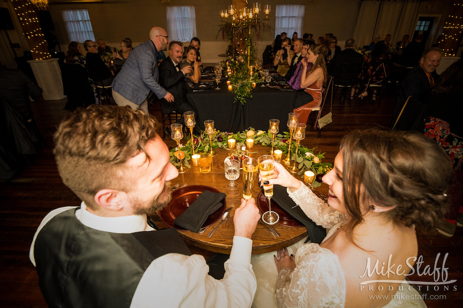 bride and groom toasting wedding reception