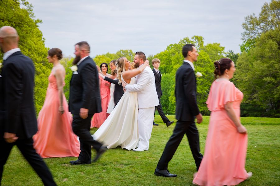 bride and groom with bridal party walking by Tokarski Wedding