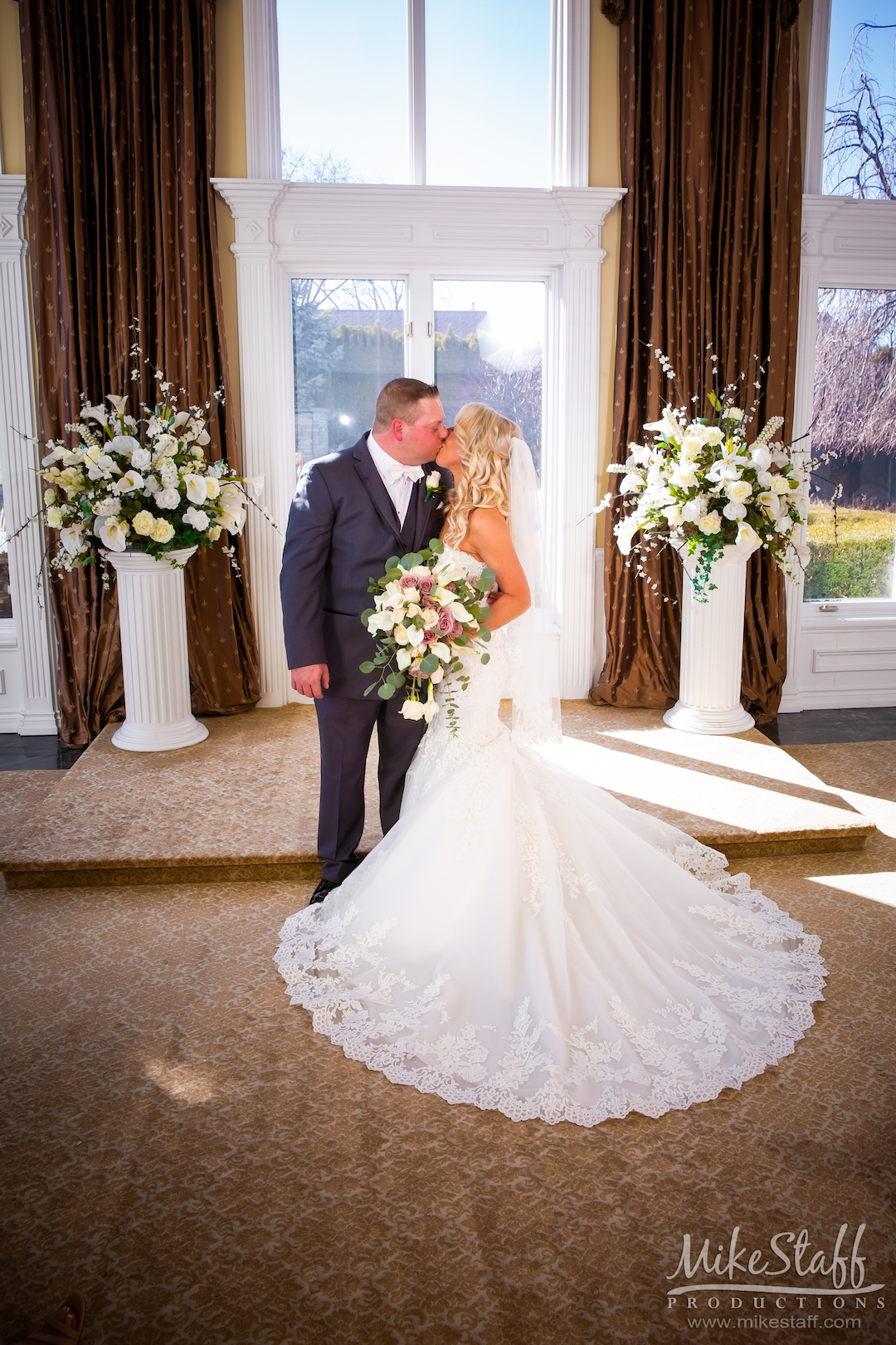 bride & groom kissing at altar