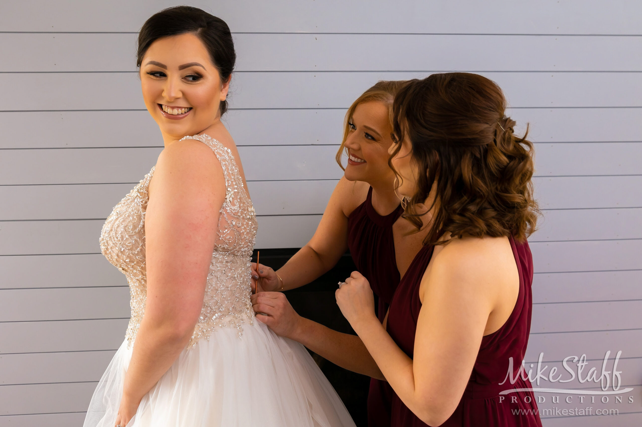 bridesmaids helping bride