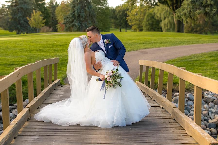 cassie-and-brandon-kissing-on-bridge-at-great-oaks