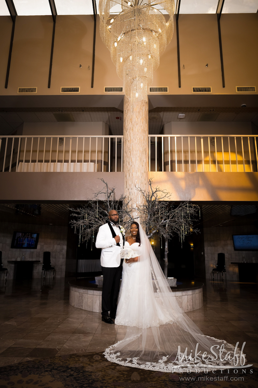 Lomyda and Eric under laurel manor chandelier