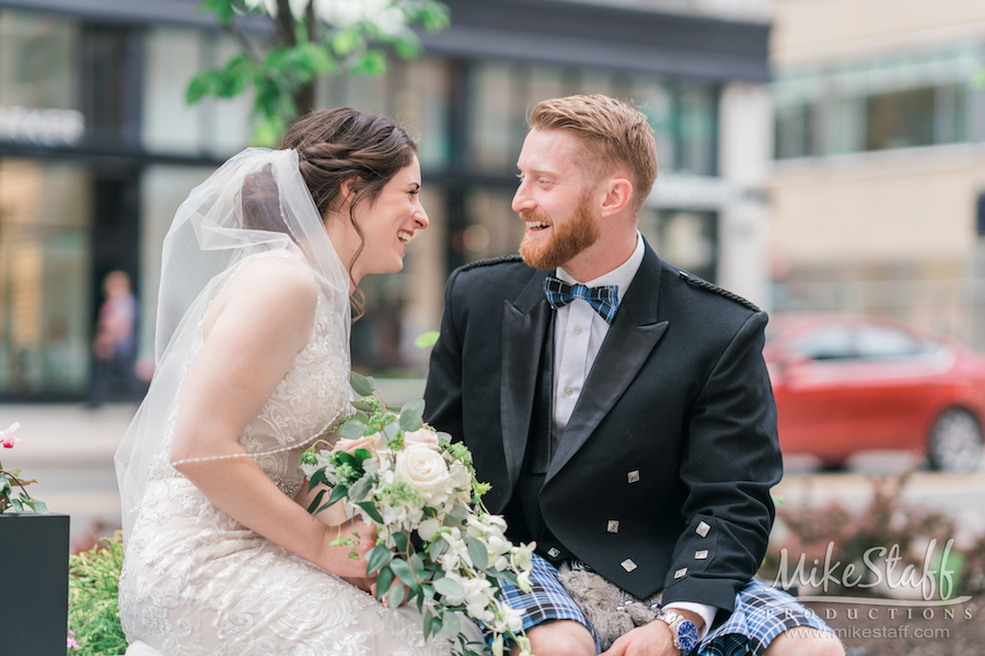 bride and groom laughing outdoors