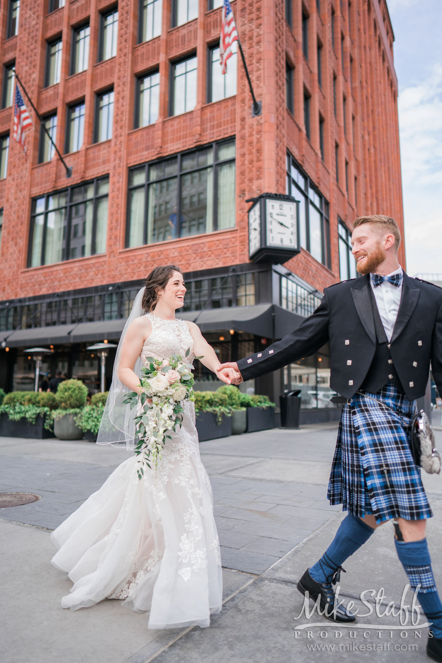 bride and groom abby garret walking holding hands