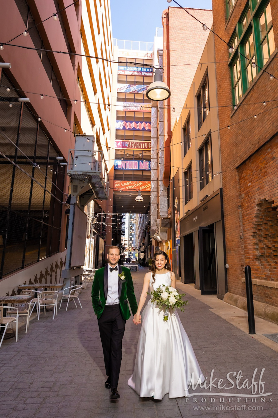 the belt downtown detroit bride and groom holding hands