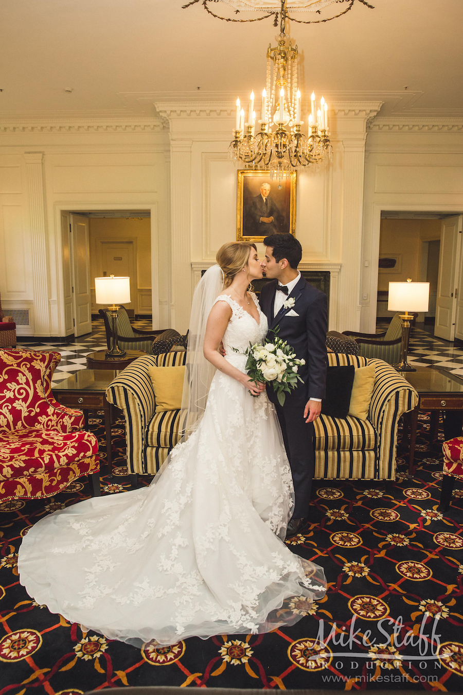 bride and groom kissing in the dearborn inn