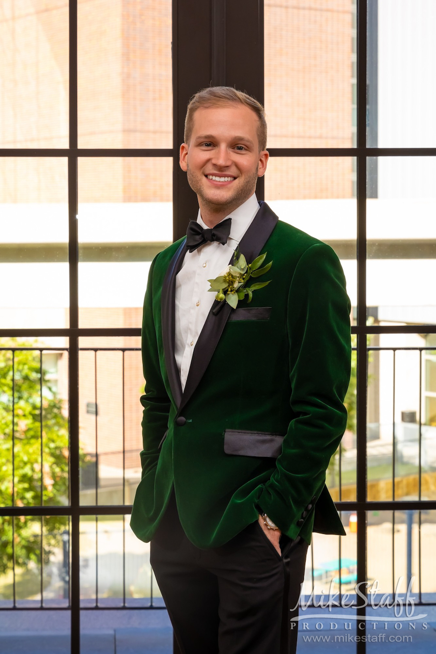 groom in dark green velvet tux