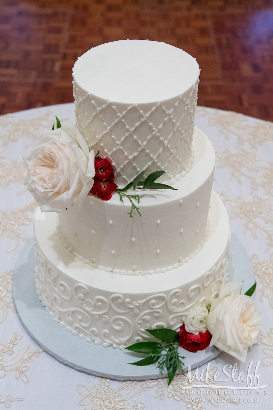 three tiered white wedding cake