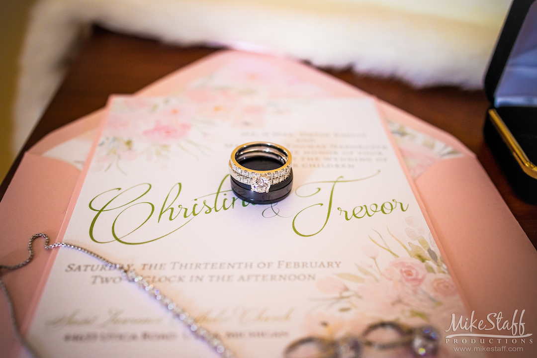 wedding rings on blush pink invitations